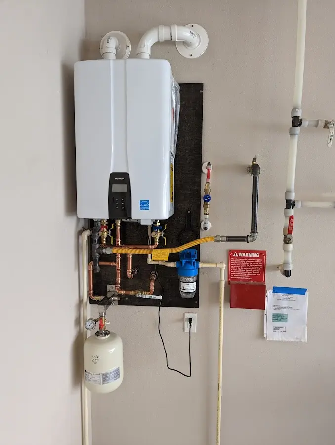 Professional plumber installing copper piping in a Good Hope home